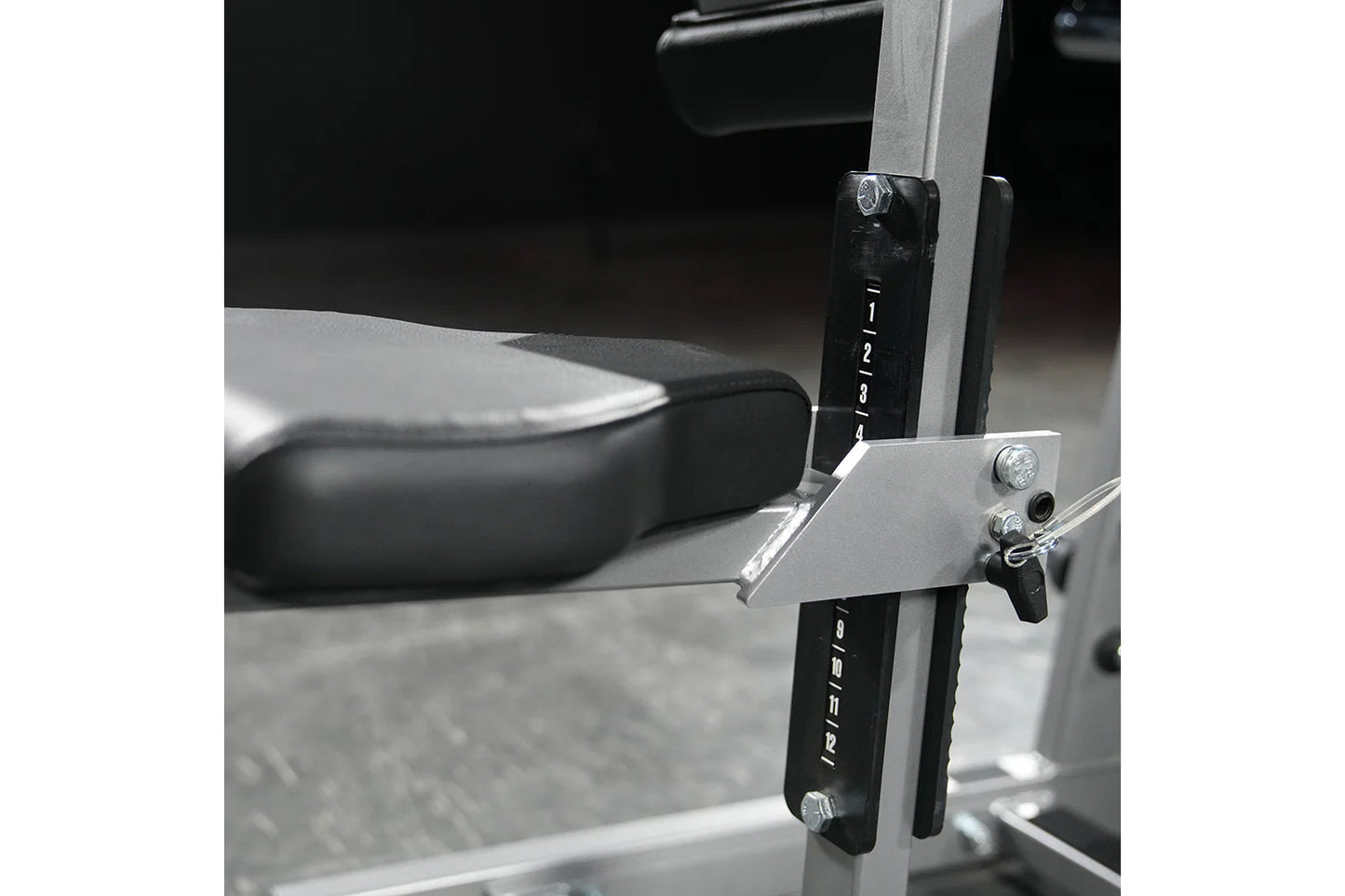 Hammer Strength plate-loaded iso-lateral wide pulldown machine with black seat and silver frame, detailed view of control arm