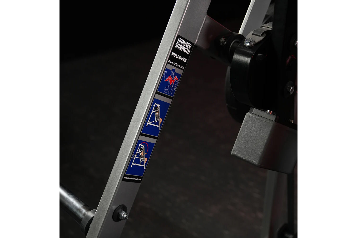 Hammer Strength plate-loaded pullover machine with silver frame, blue instruction decals, and black seat, detail view