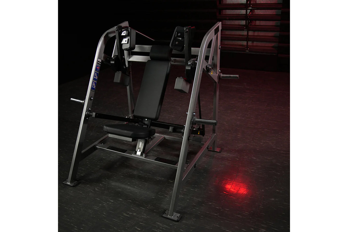 Hammer Strength plate-loaded pullover machine with black padded seat, silver frame, and digital controls on dark gym floor