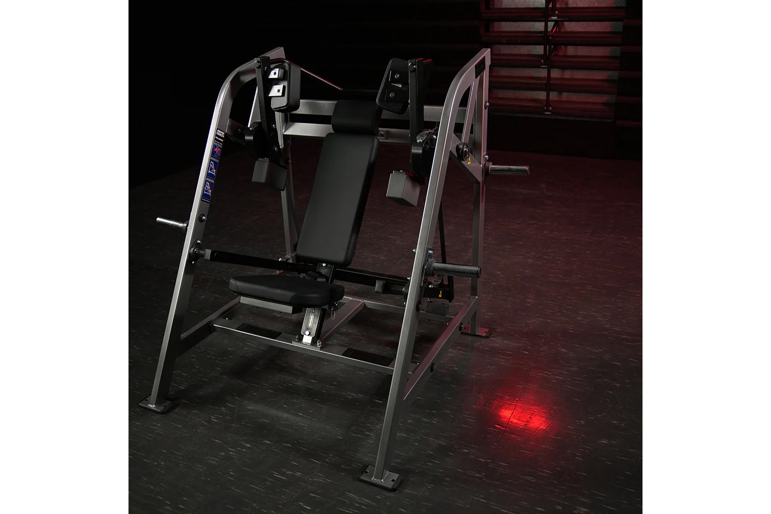 Hammer Strength plate-loaded pullover machine with black padded seat, silver frame, and digital controls on dark gym floor