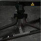 Black plate-loaded seated biceps machine with curved handles and metal frame, front view