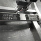 Hammer Strength plate-loaded seated calf raise machine with black and silver frame detail showing branded footplate