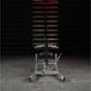 Hammer Strength plate-loaded seated calf raise machine with silver frame, burgundy seat, and black accents in gym setting