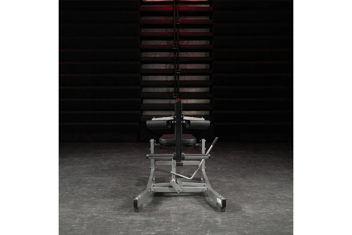 Hammer Strength plate-loaded seated calf raise machine with silver frame, burgundy seat, and black accents in gym setting