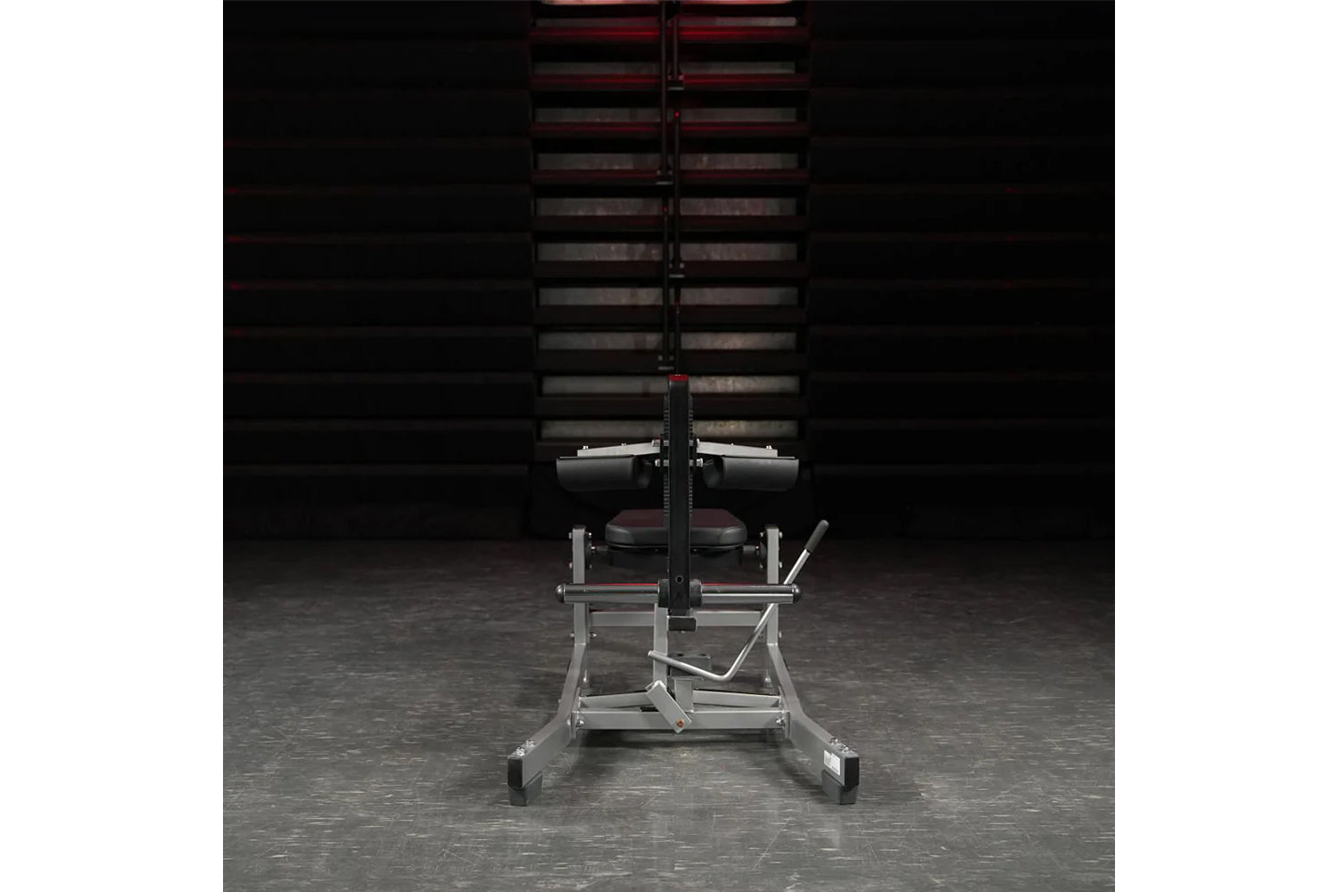Hammer Strength plate-loaded seated calf raise machine with silver frame, burgundy seat, and black accents in gym setting