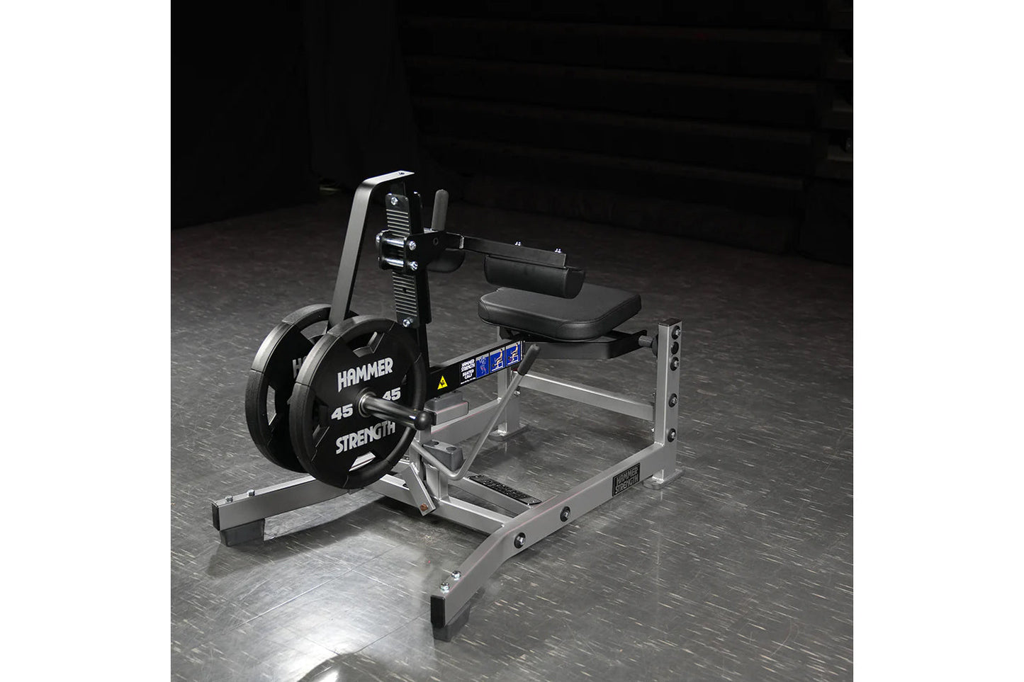 Hammer Strength plate-loaded seated calf raise machine with 45-pound weight plates, silver metal frame, and black padded seat