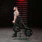 Man using black Hammer Strength plate-loaded shrug machine with 45-pound weight plates in gym setting