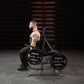 Hammer Strength plate-loaded shrug machine with 45-pound weight plates, shown in gym setting with male model demonstrating us
