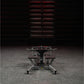 Hammer Strength plate-loaded T-bar row machine with curved handles and weight plates, front view in gym setting