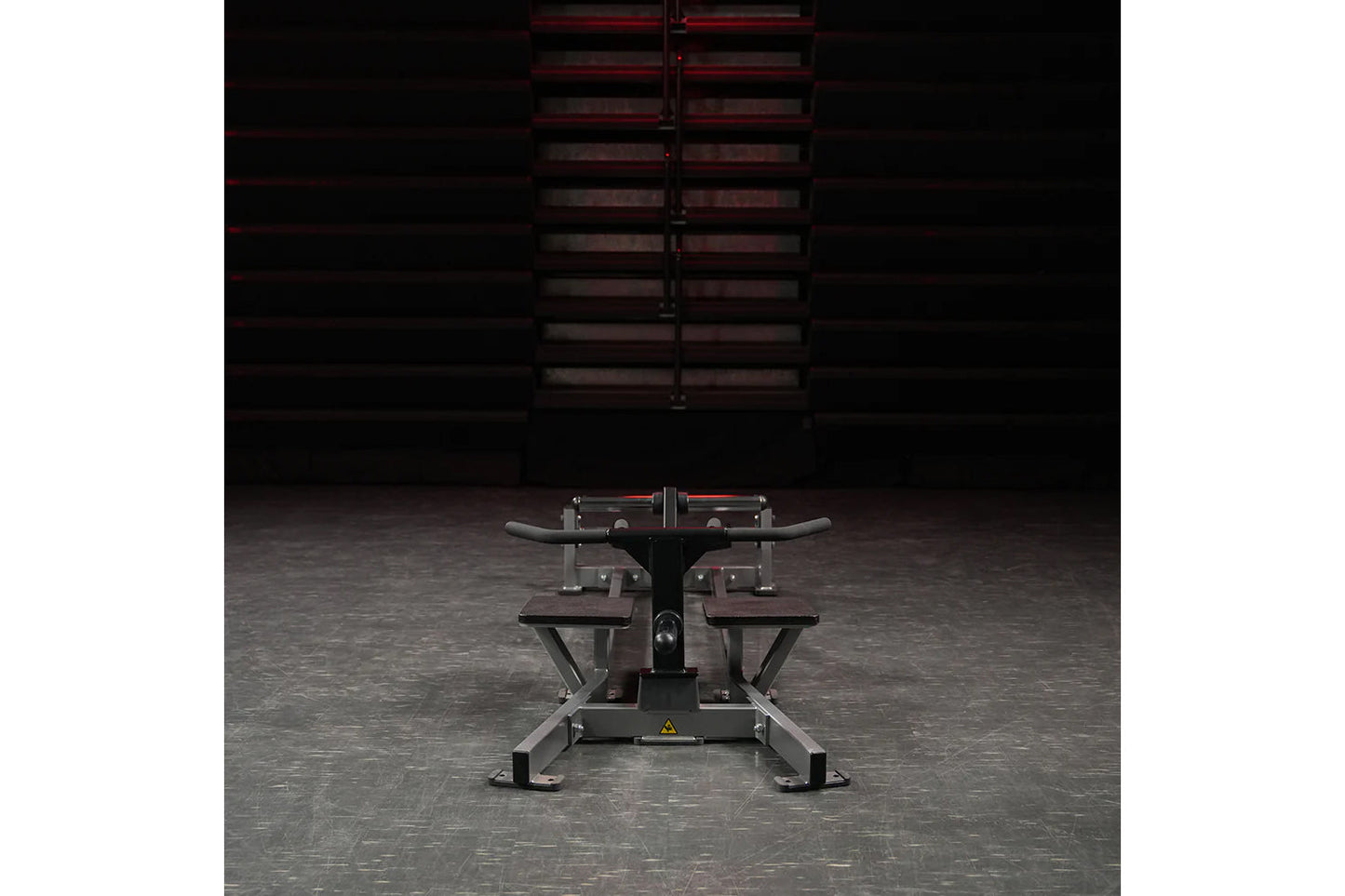 Hammer Strength plate-loaded T-bar row machine with curved handles and weight plates, front view in gym setting