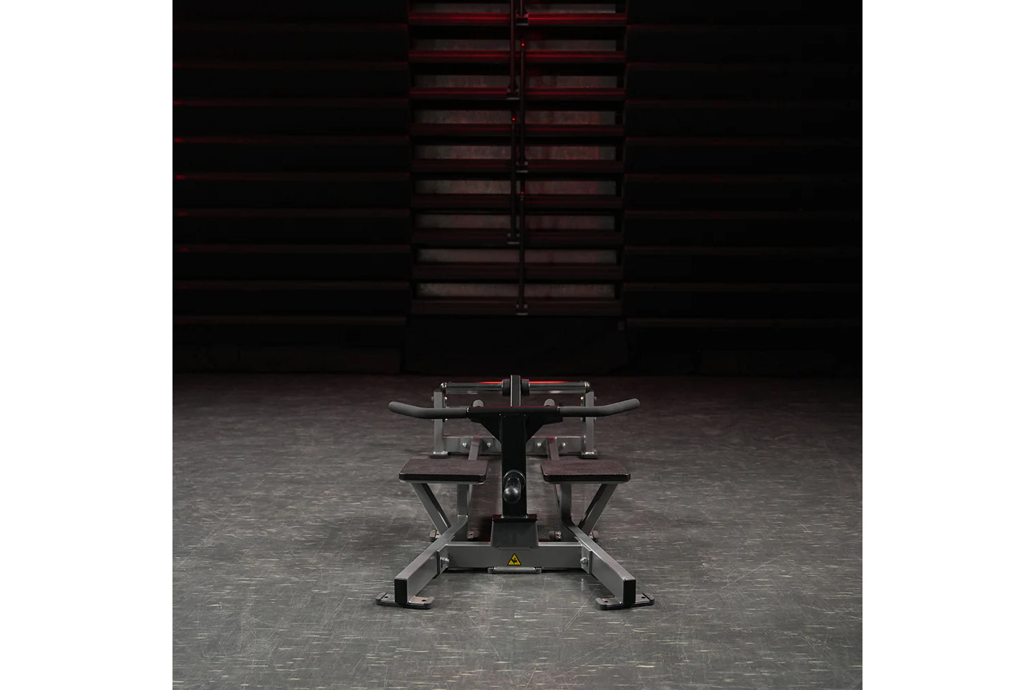 Hammer Strength plate-loaded T-bar row machine with curved handles and weight plates, front view in gym setting