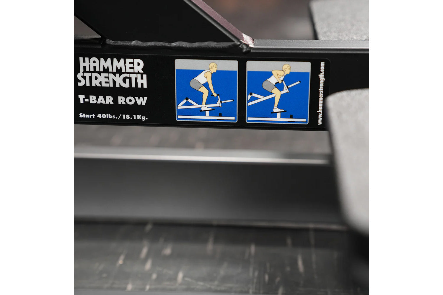 Hammer Strength T-bar row machine label with white text and instructional icons showing exercise form on blue background