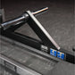 Hammer Strength plate-loaded T-bar row machine with chrome handlebar and white grip pad, black frame on dark background