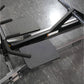 Hammer Strength plate-loaded T-bar row machine with black handles and gray textured foot platforms on diamond plate base