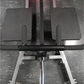 Hammer Strength plate-loaded T-bar row machine with gray padded foot plates, black handlebar, and chrome base on textured gra