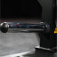 Black plate-loaded T-bar row machine with cylindrical steel bar and round grip handles on dark background
