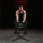 Muscular man in black tank top performing T-bar row exercise on Hammer Strength plate-loaded machine with 45-pound weight pla