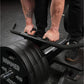 Person using Hammer Strength plate-loaded T-bar row machine with black weight plates and handlebar grip