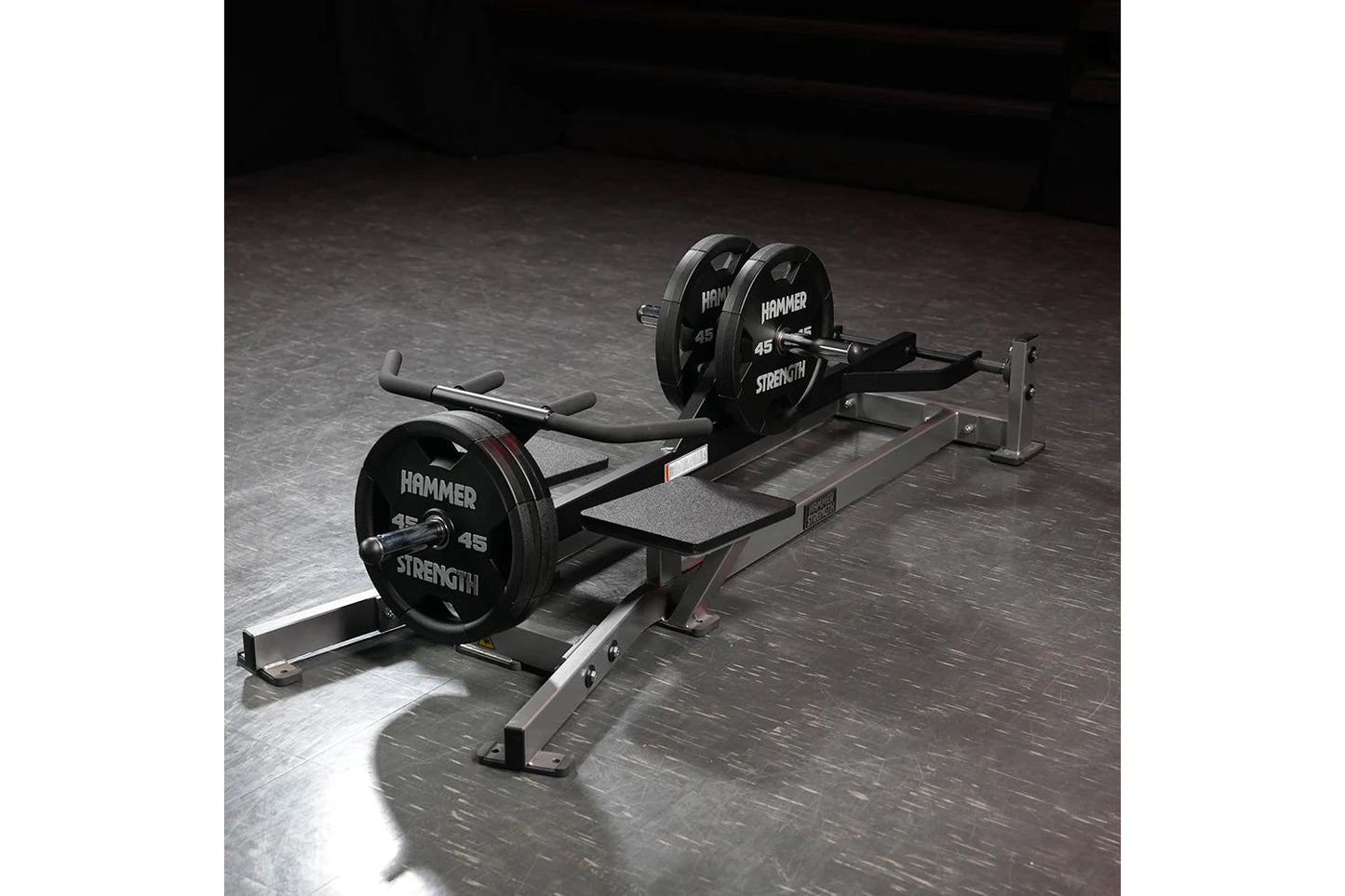 Hammer Strength plate-loaded T-bar row machine with 45-pound weights loaded on barbell, featuring foam handles and steel fram