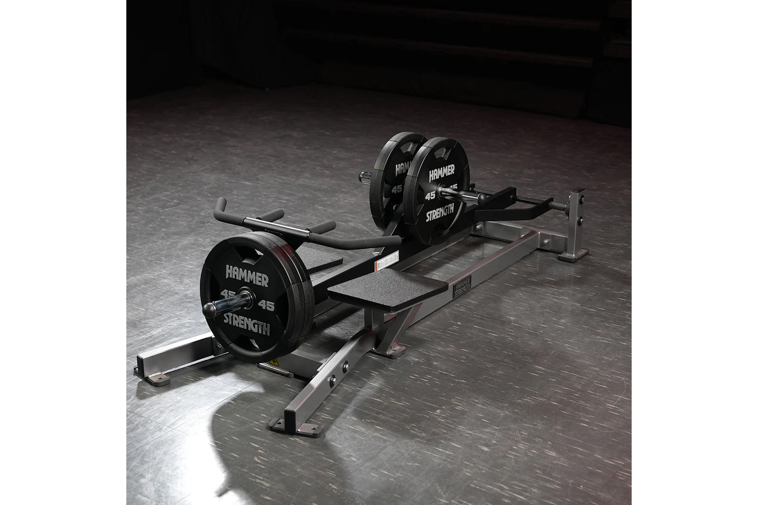 Hammer Strength plate-loaded T-bar row machine with 45-pound weights loaded on barbell, featuring foam handles and steel fram