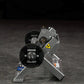 Hammer Strength black plate-loaded tibia dorsi flexion bench machine with weight plate, displayed on dark textured surface