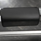 Black leather padded arm roll attachment for exercise machine, close-up view