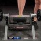 Person performing leg exercise on Hammer Strength plate-loaded tibia dorsi flexion machine with black weight plates attached 