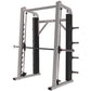 Gray and black plate-loaded Smith machine with dual weight pegs, padded uprights, and horizontal barbell on white background