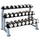 Three-tiered dumbbell rack with gray steel frame holding black dumbbells with chrome heads and white grip labels on white bac