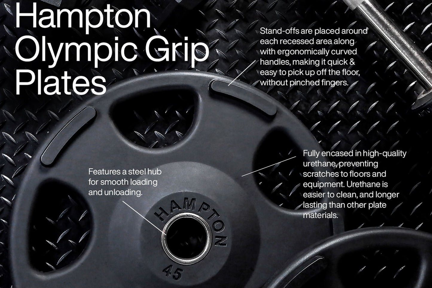 Black urethane Olympic weight plate with steel hub and ergonomic handles, displayed on checkered metal surface