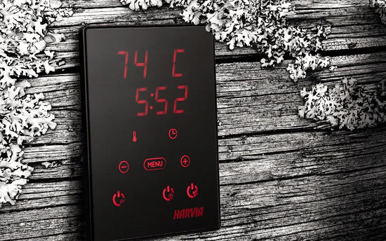 Black Harvia sauna heater control panel with red LED display showing temperature 74°C and time 5:52, red touch buttons, on we