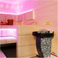 Harvia Spirit electric sauna heater with rocks in cedar-lined sauna room with pink neon lighting