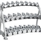 Three-tier chrome dumbbell rack with gray metal frame holding multiple pairs of silver dumbbells with white label plates