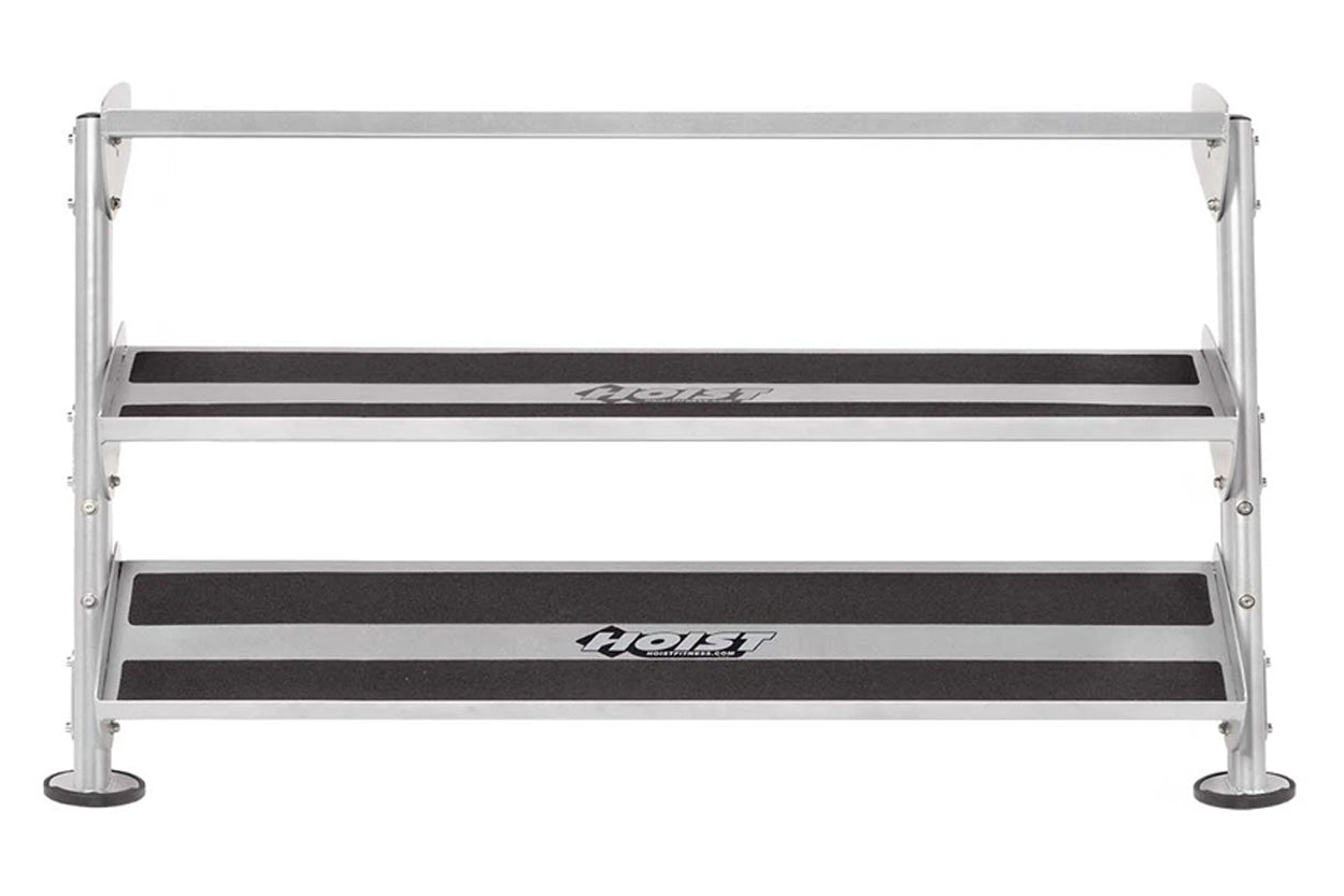 Silver aluminum dumbbell rack with two black rubber-topped tiers and stabilizing feet, viewed from front on white background