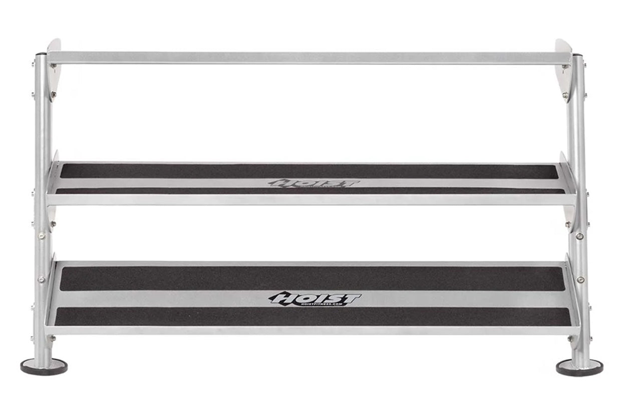 Silver aluminum dumbbell rack with three tiers and black rubber-grip steps, Hoist brand, on white background