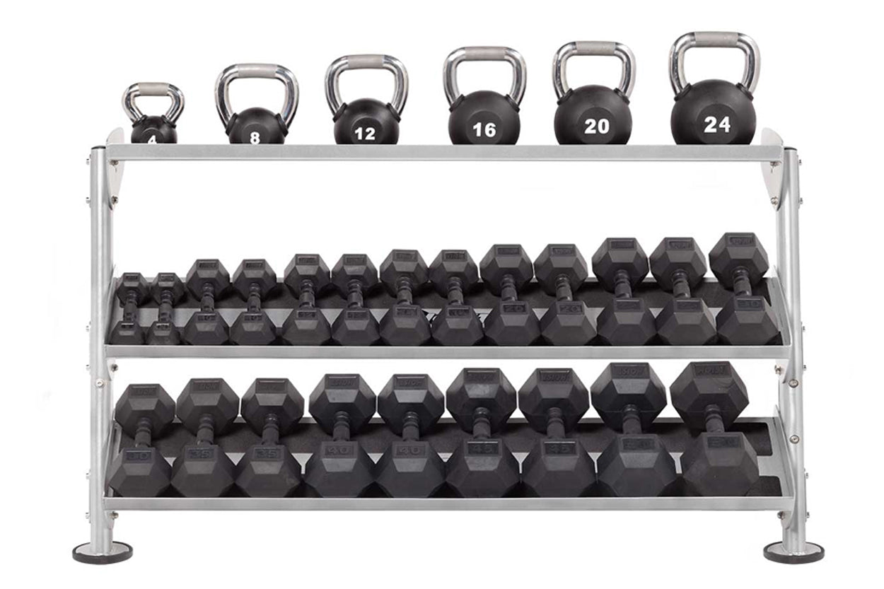 Silver metal dumbbell rack with three tiers holding black hexagonal dumbbells ranging from 8 to 24 pounds, and kettlebells on