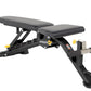 Hoist 7-Position FID weight bench with black padded seat and back, adjustable frame with yellow knobs, and leg extension atta