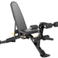 Black adjustable weight bench with padded seat and backrest, leg extension and curl attachment with black knurled handles, on