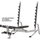 Hoist 7-position Olympic bench press with gray steel frame, black padding, dual uprights with dumbbell racks, and adjustable 