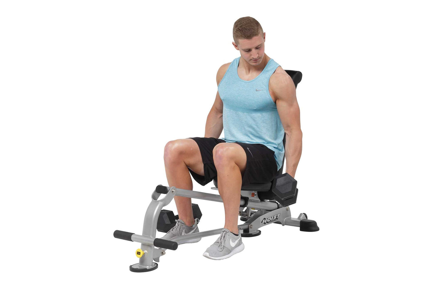 Male model wearing light blue tank top and black shorts using silver and black weight bench with adjustable seat and leg exte