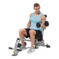 Man in light blue tank top and black shorts performing dumbbell exercise on gray and black folding weight bench