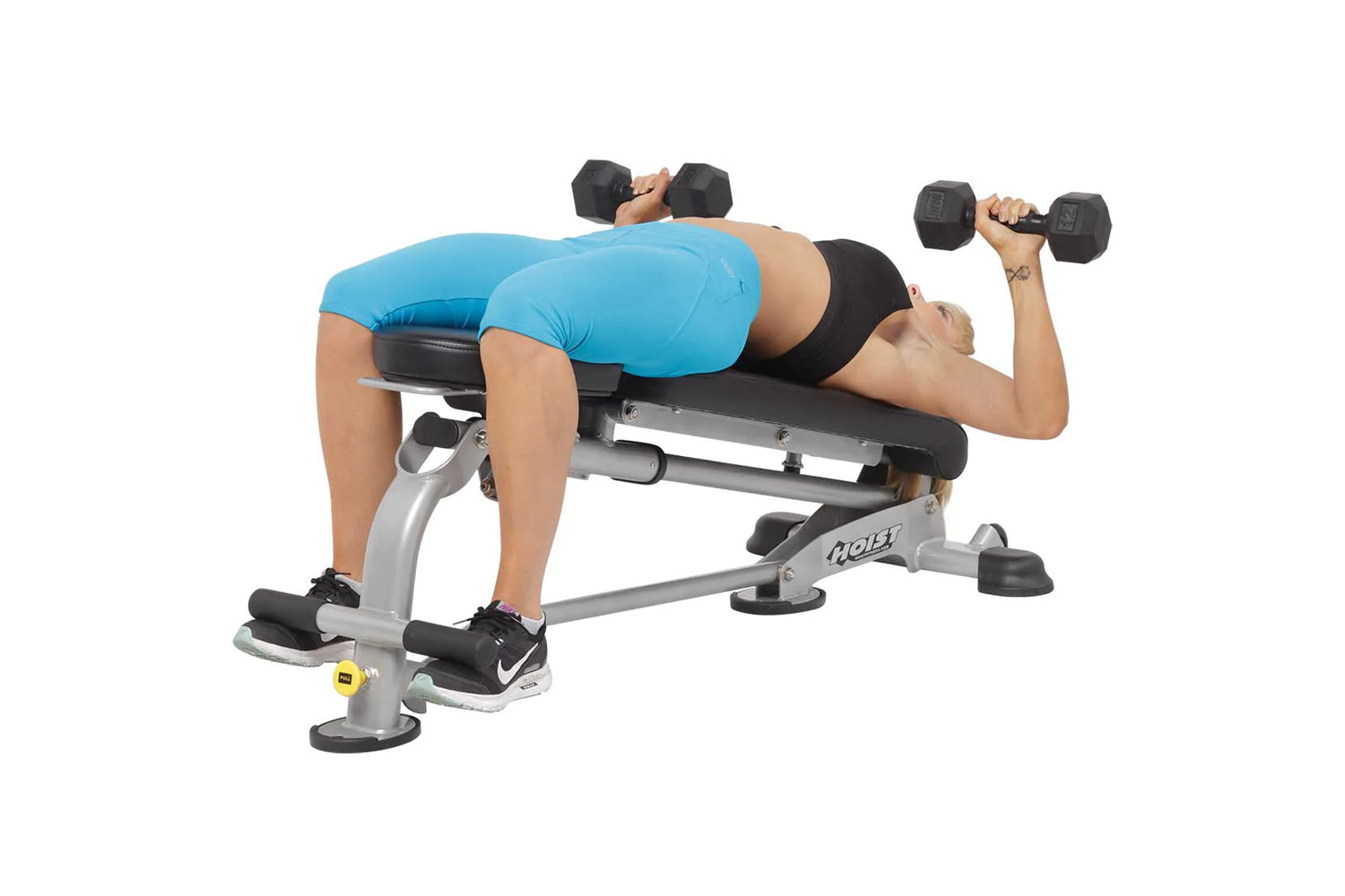 Person demonstrating dumbbell chest press on gray and black Hoist adjustable weight bench with foot platform