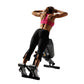Woman performing abdominal exercise on black Hoist Ab/Back Hyper Bench, wearing pink sports bra and black leggings