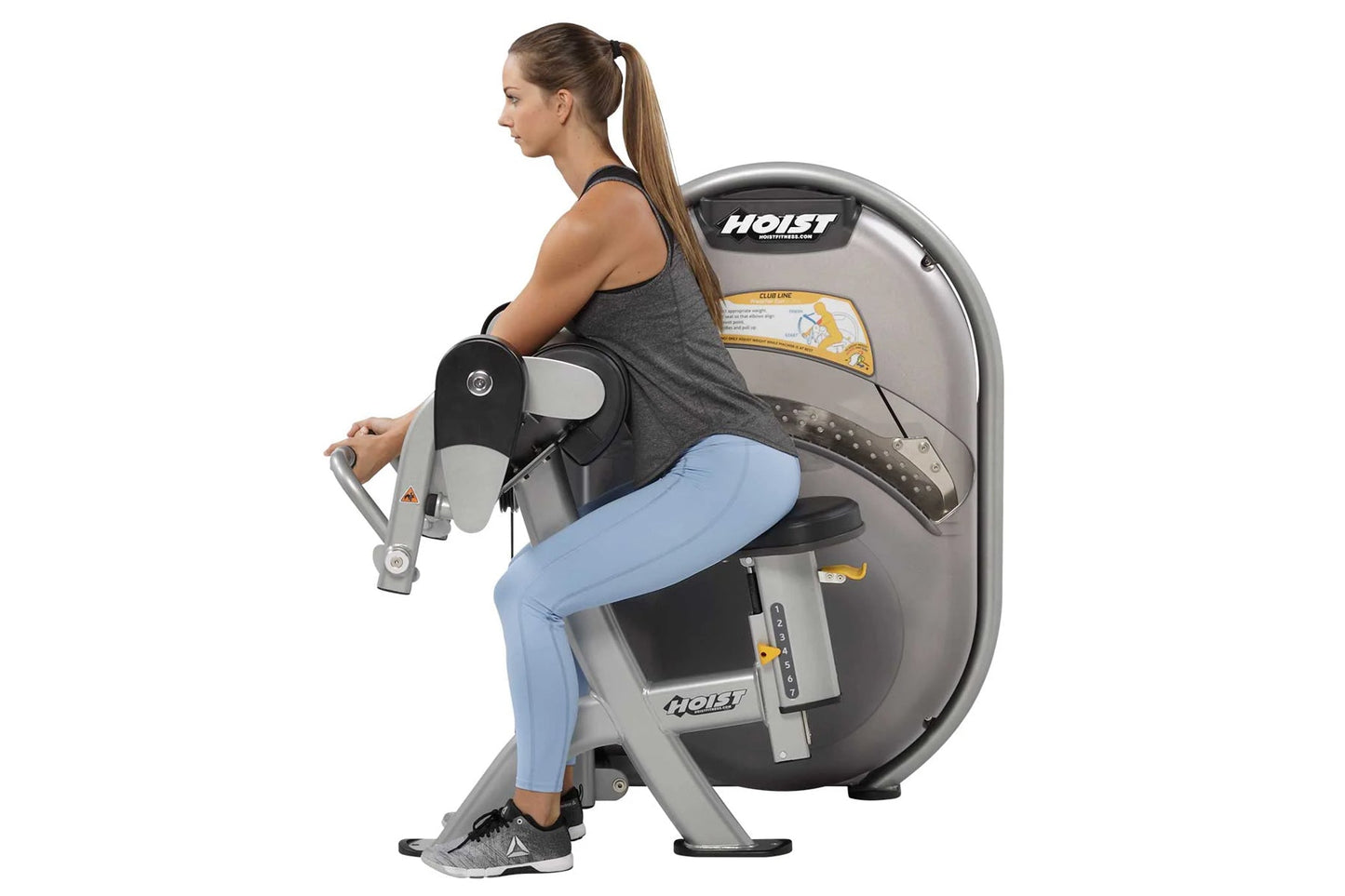 Woman using Hoist Biceps Curl machine, gray and black equipment with digital display, worn by model in gray tank top and ligh