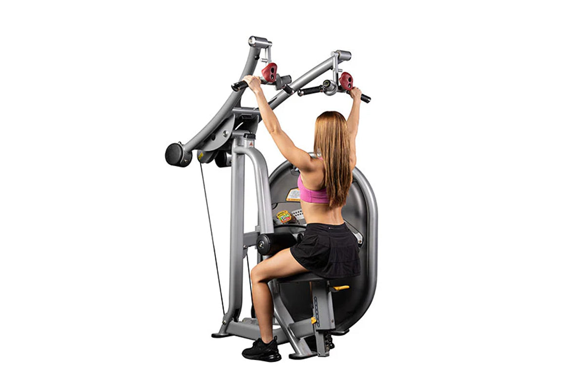 Woman using Hoist Lat Pulldown machine with gray frame and red handles on white background
