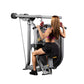 Woman using gray and black Hoist lat pulldown machine with red handles, seated on black padded seat performing exercise
