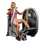Woman in pink sports bra and shorts using black and silver Hoist chest press machine with yellow handles on white background
