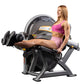 Woman in pink sports bra and shorts using black and gray Hoist leg extension machine with circular pad and foot platform, sho