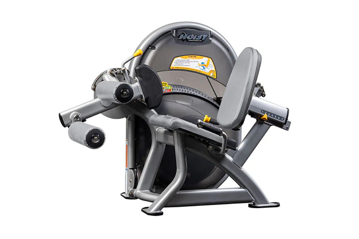 Hoist Club Line Leg Curl machine with gray cushioned seat, silver metal frame, and dual rotating leg attachment pads on white