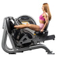 Woman in pink sports bra and shorts using Hoist leg press machine with black and gray frame on white background